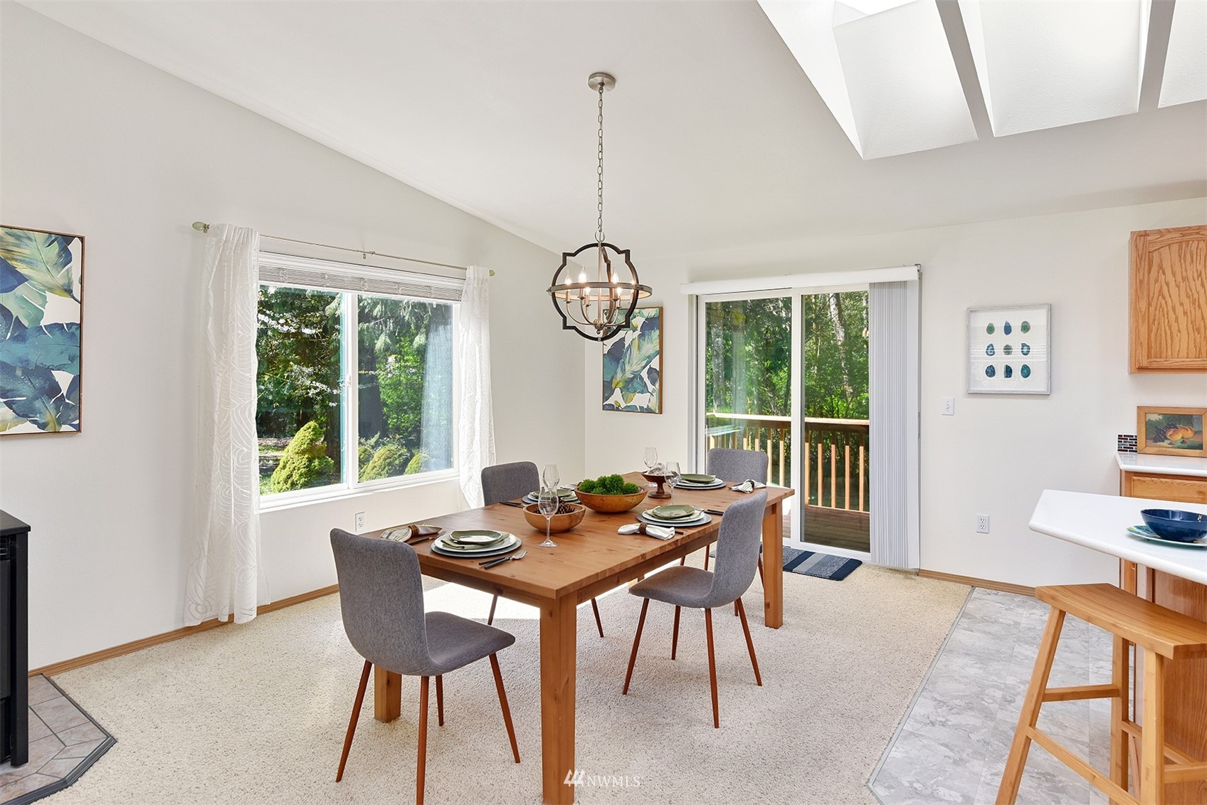 8963 Miller Road Northeast Bainbridge Island, WA 98110 - Photo 13 of 35 a dining room with furniture a chandelier and a rug