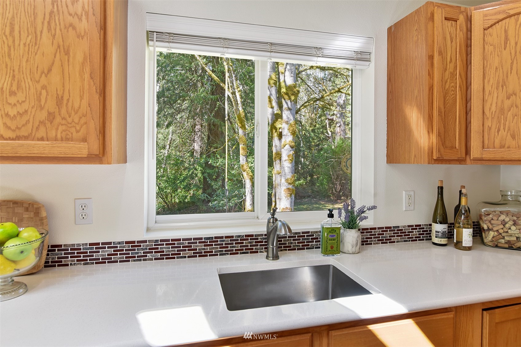 8963 Miller Road Northeast Bainbridge Island, WA 98110 - Photo 16 of 35 a kitchen with a sink a counter and a window