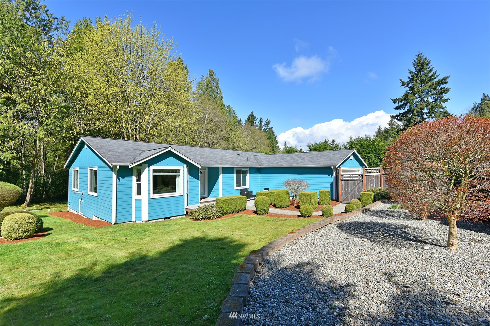 8963 Miller Road Northeast Bainbridge Island, WA 98110 - Photo 2 of 35 a front view of a house with garden