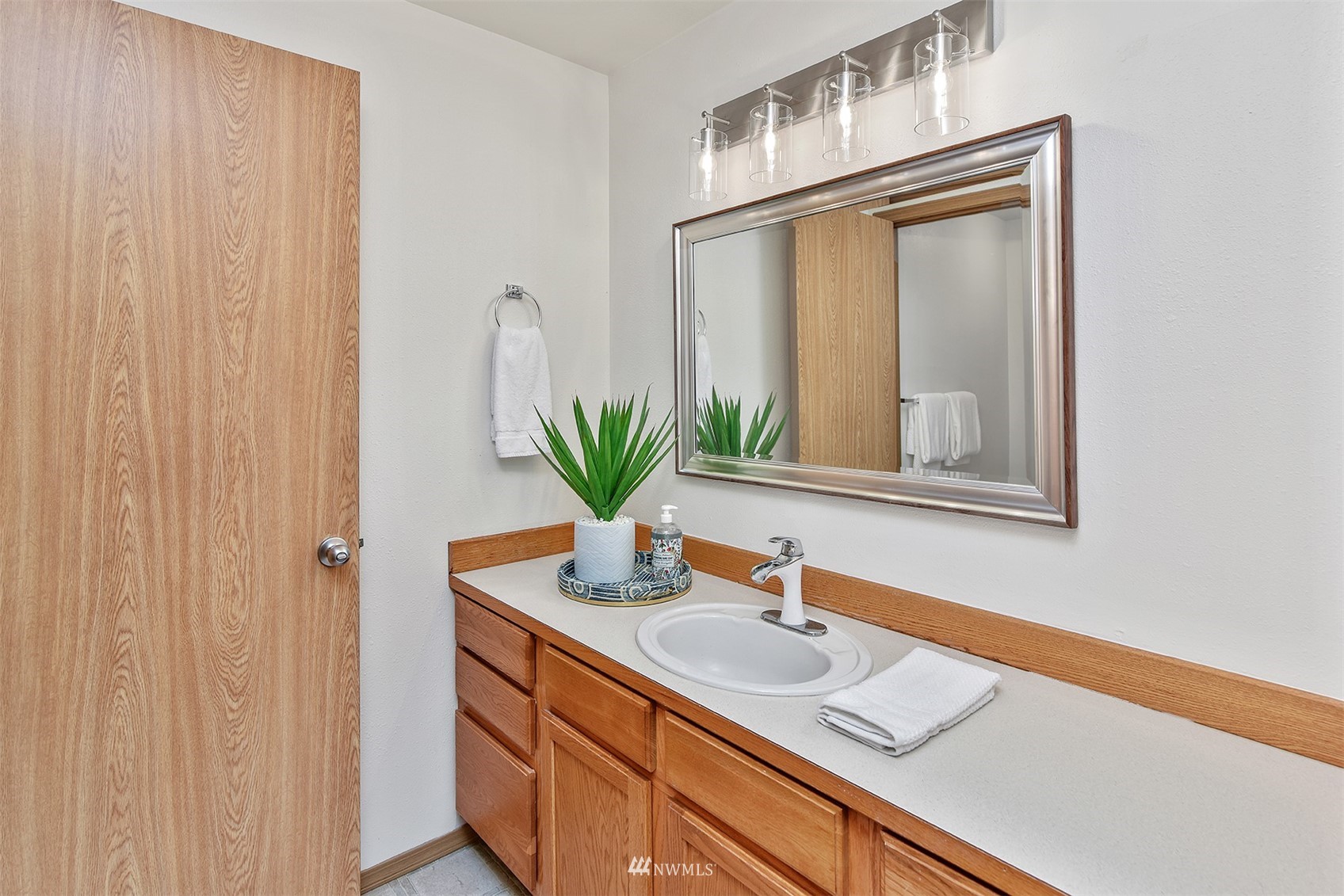 8963 Miller Road Northeast Bainbridge Island, WA 98110 - Photo 21 of 35 a bathroom with a granite countertop sink and a mirror