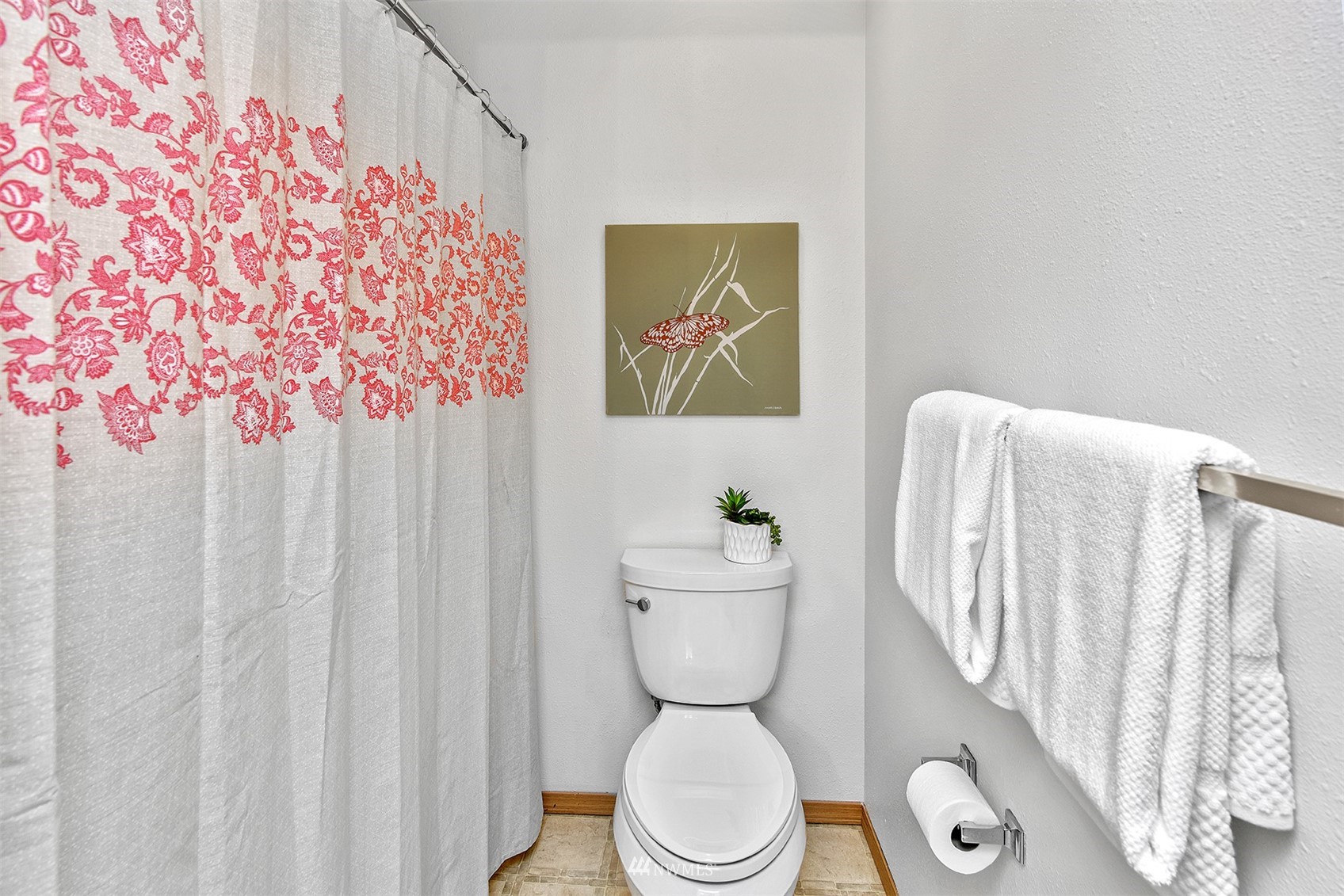 8963 Miller Road Northeast Bainbridge Island, WA 98110 - Photo 22 of 35 a bathroom with a toilet and a shower curtain