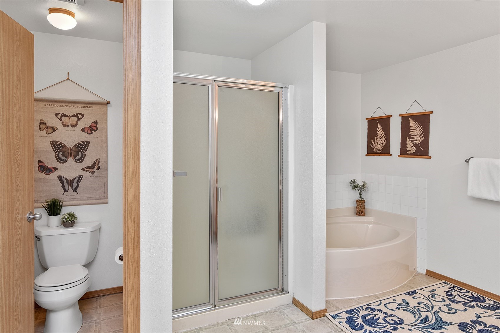 8963 Miller Road Northeast Bainbridge Island, WA 98110 - Photo 28 of 35 a white toilet sitting next to a bathroom sink