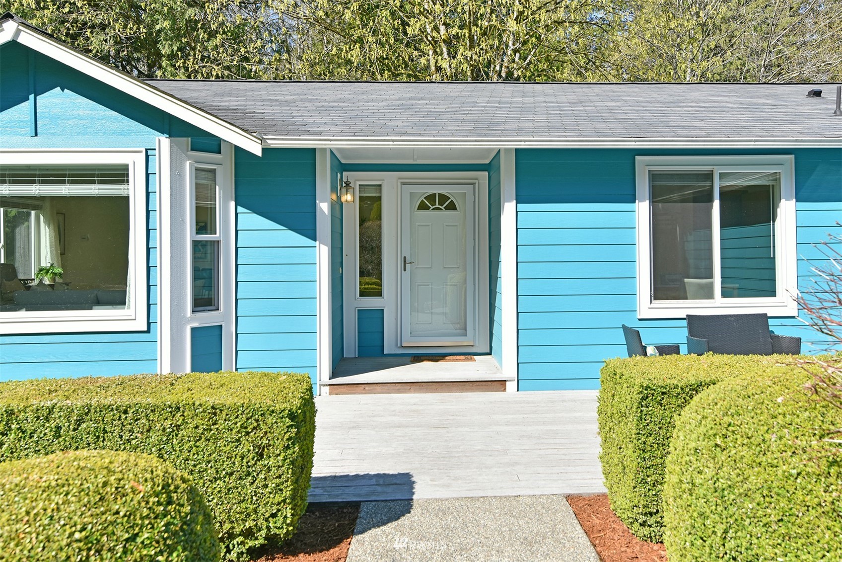 8963 Miller Road Northeast Bainbridge Island, WA 98110 - Photo 3 of 35 a front view of a house with a garden