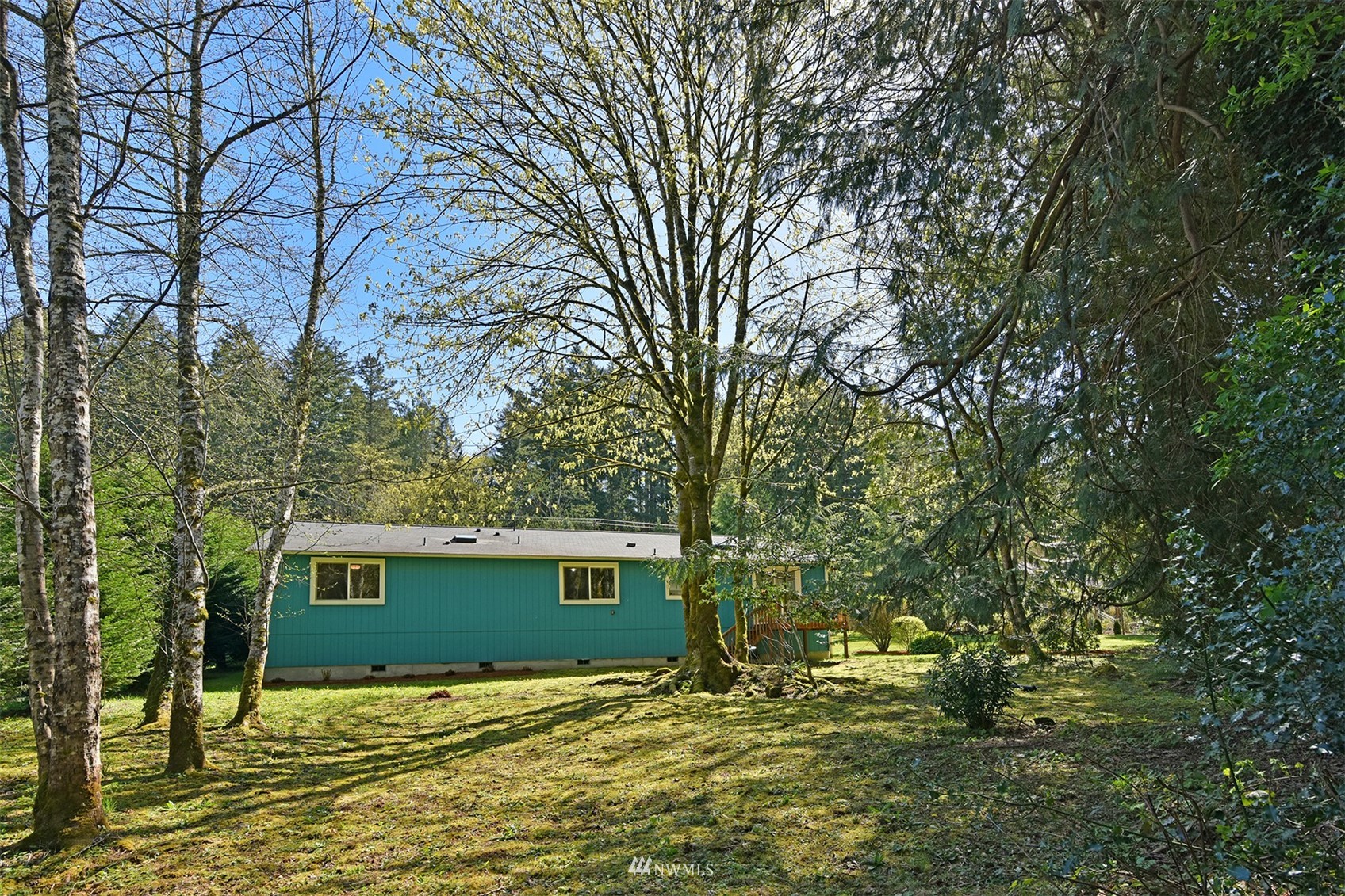 8963 Miller Road Northeast Bainbridge Island, WA 98110 - Photo 33 of 35 a view of a house with a yard
