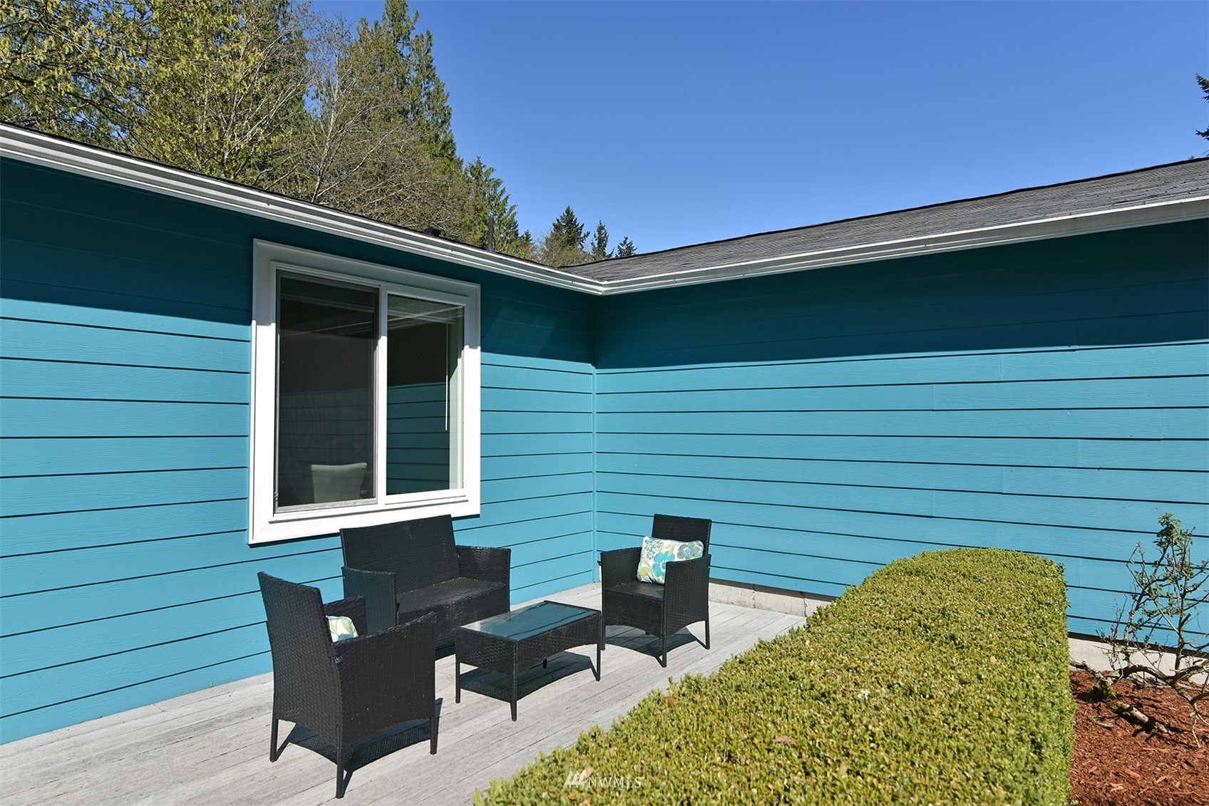 8963 Miller Road Northeast Bainbridge Island, WA 98110 - Photo 4 of 35 a backyard of a house with table and chairs