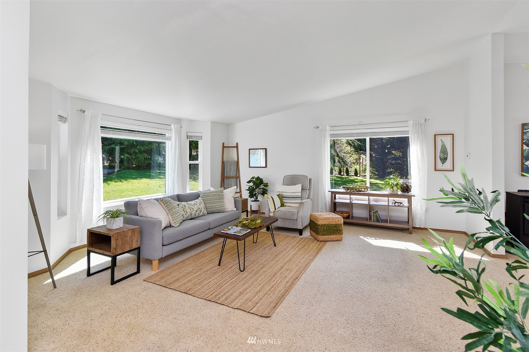 8963 Miller Road Northeast Bainbridge Island, WA 98110 - Photo 8 of 35 a living room with furniture and a large window