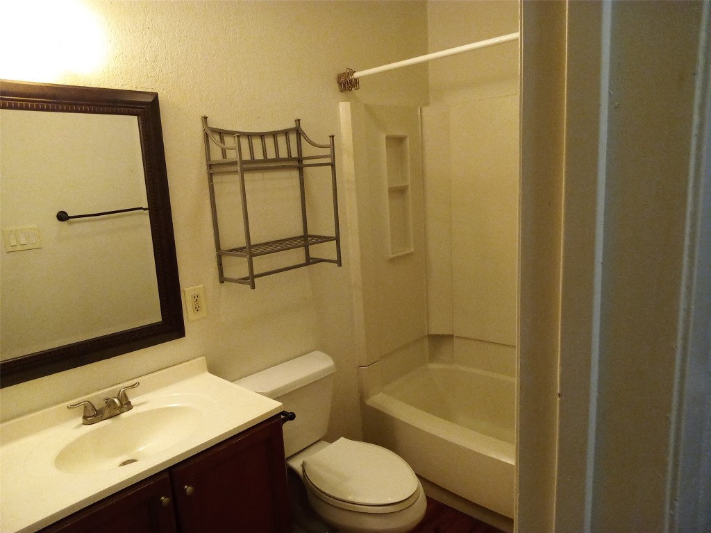 907 B Sirocco Drive Austin, TX 78745 - Photo 11 of 20 a bathroom with a sink a toilet and shower