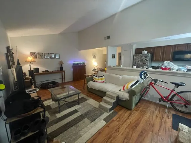 a living room with furniture and a wooden floor