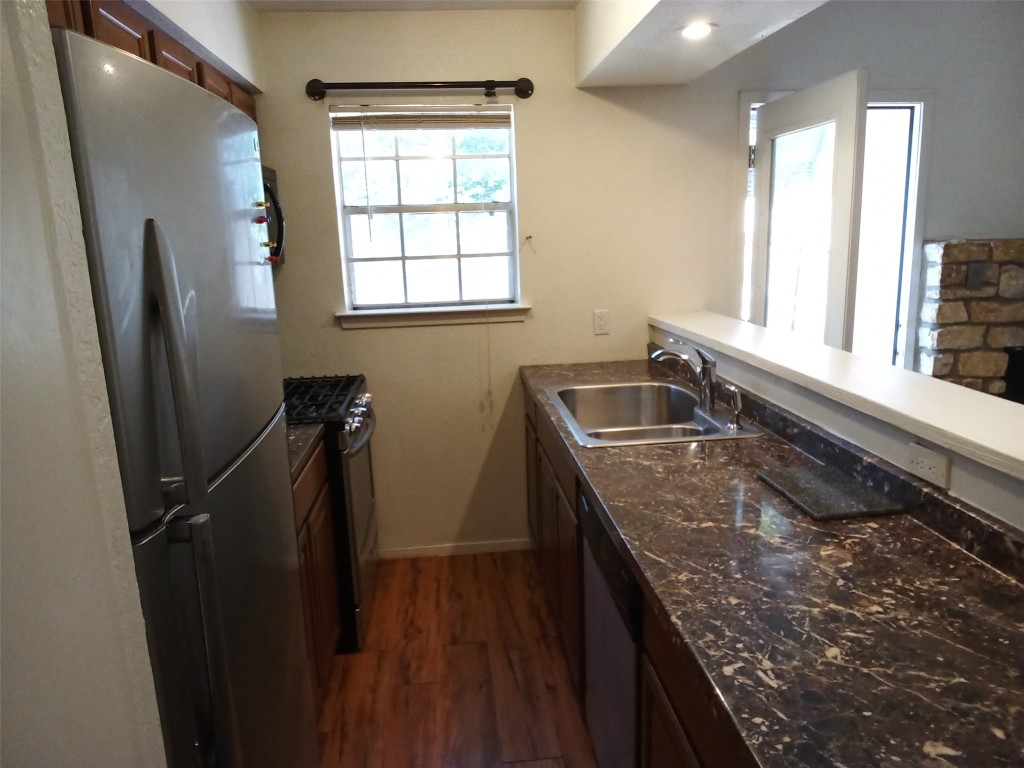 907 B Sirocco Drive Austin, TX 78745 - Photo 7 of 20 a kitchen with sink window and refrigerator