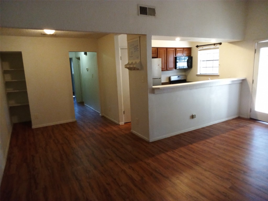 907 B Sirocco Drive Austin, TX 78745 - Photo 8 of 20 a kitchen with stainless steel appliances granite countertop a refrigerator and a stove top oven