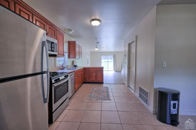 a view of a kitchen with wooden floor and stairs
