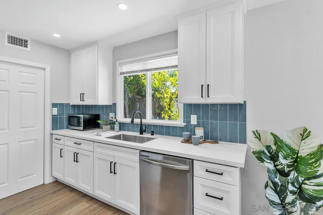12208 Witt Road Poway, CA 92064 - Photo 11 of 43 a kitchen with a sink stove and cabinets