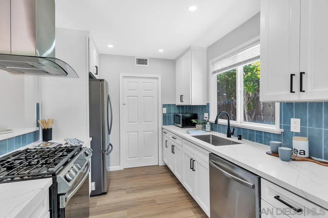 12208 Witt Road Poway, CA 92064 - Photo 13 of 43 a kitchen with a sink stove and refrigerator