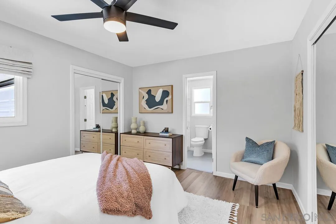 12208 Witt Road Poway, CA 92064 - Photo 17 of 43 a spacious bedroom with a bed and a chair