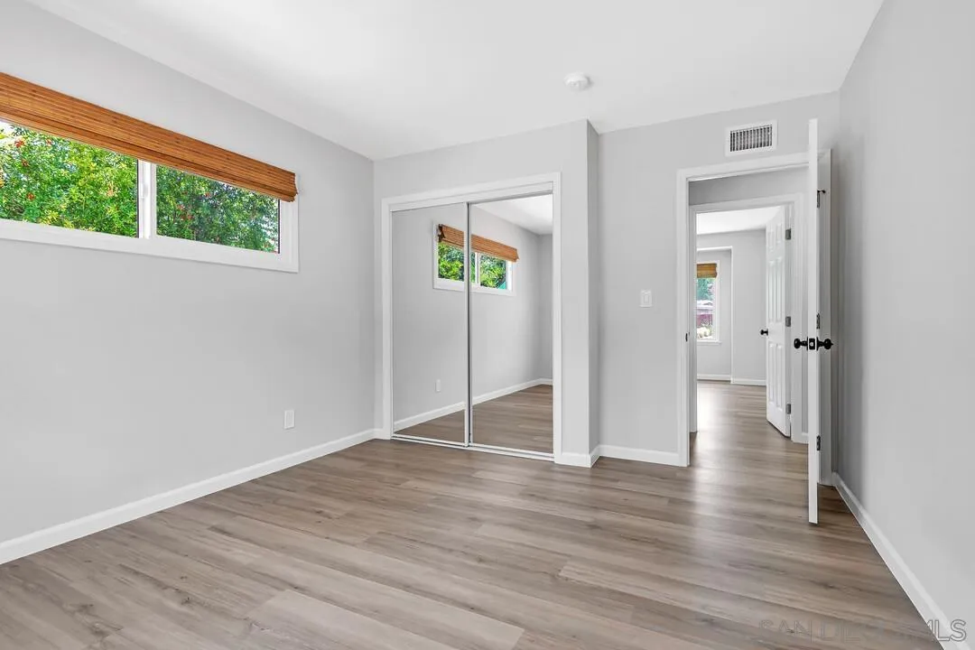 12208 Witt Road Poway, CA 92064 - Photo 22 of 43 a view of a hallway with wooden floor and closet