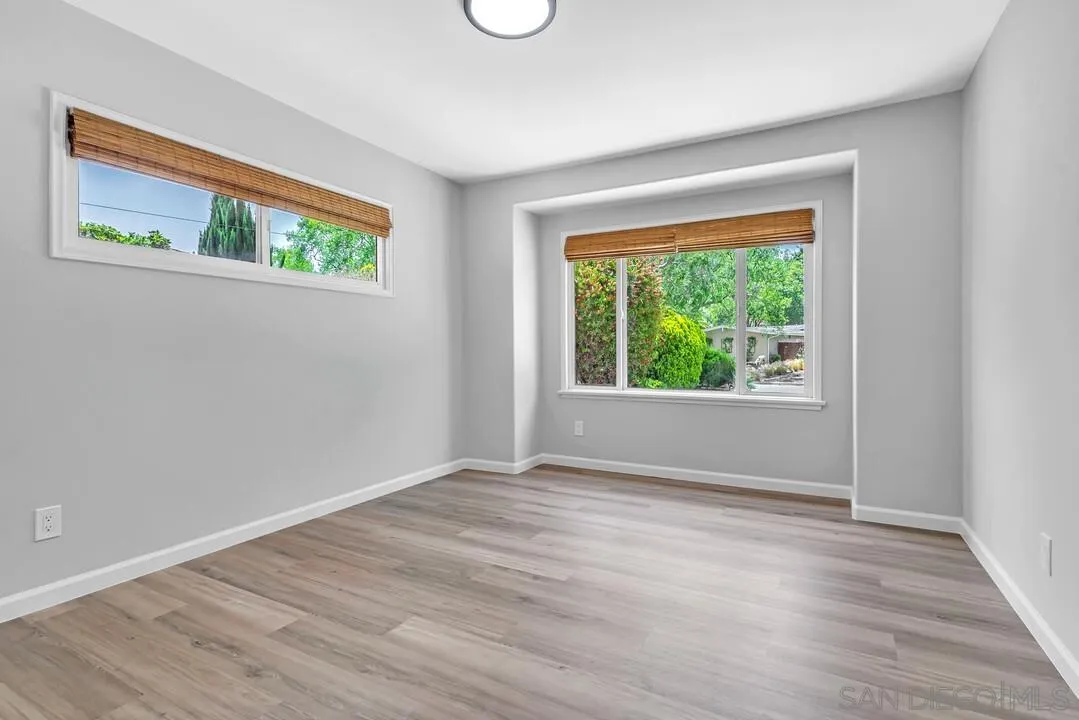 12208 Witt Road Poway, CA 92064 - Photo 24 of 43 a view of an empty room with wooden floor and a window