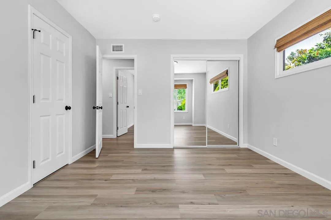 12208 Witt Road Poway, CA 92064 - Photo 25 of 43 a view of an empty room with wooden floor and a window
