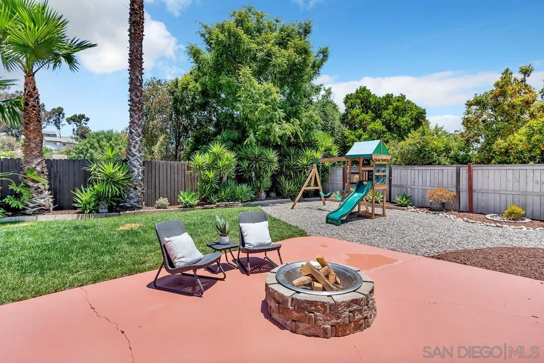 12208 Witt Road Poway, CA 92064 - Photo 36 of 43 a view of a backyard with table and chairs potted plants and palm tree