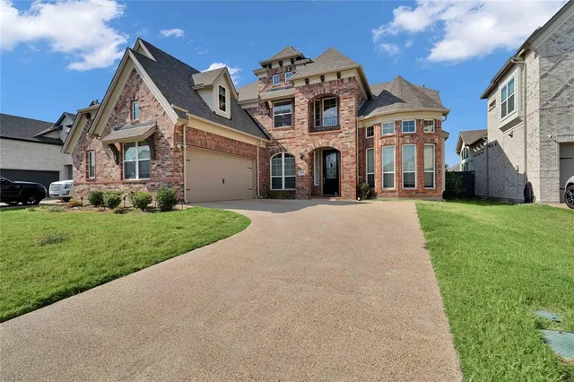 a front view of a building with a yard