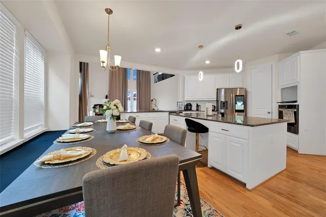 a kitchen with a dining table chairs sink and microwave
