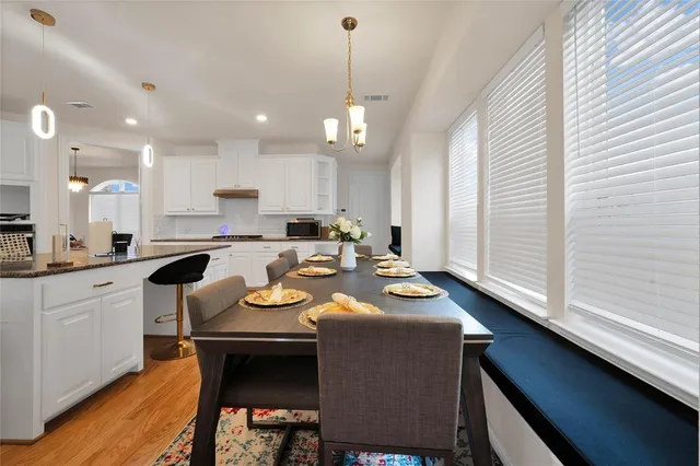 a large kitchen with a table and chairs