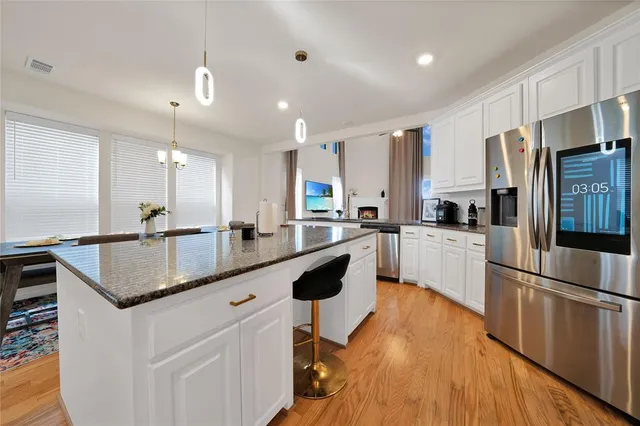 a kitchen with refrigerator and cabinets