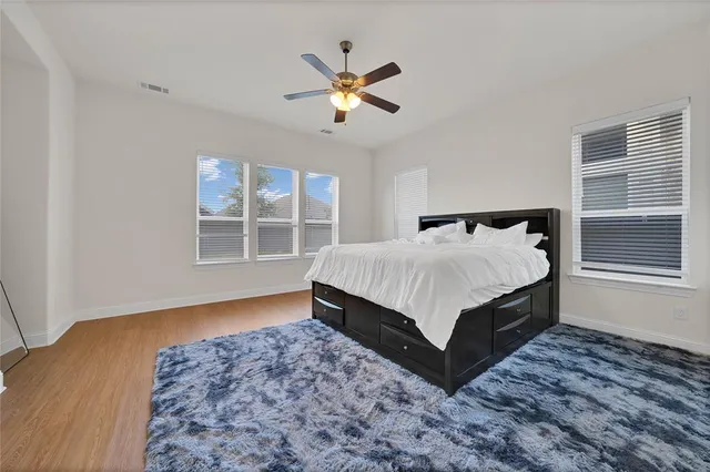 a spacious bathroom with a tub sink and mirror