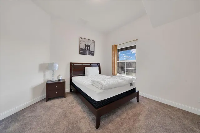 a large bed sitting in a bedroom and table
