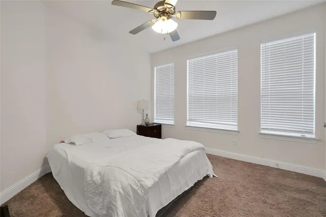 a bathroom with a tub a sink double vanity and a mirror