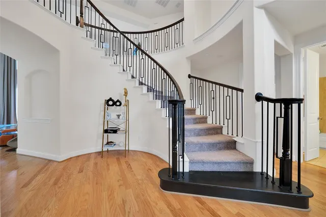 a view of entryway and hall with wooden floor