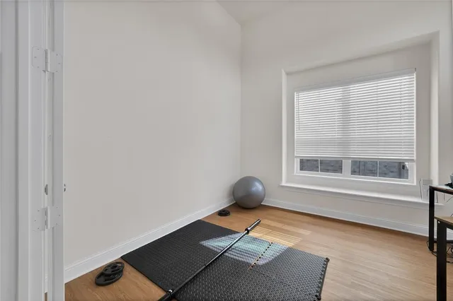 a living room with a window and a rug