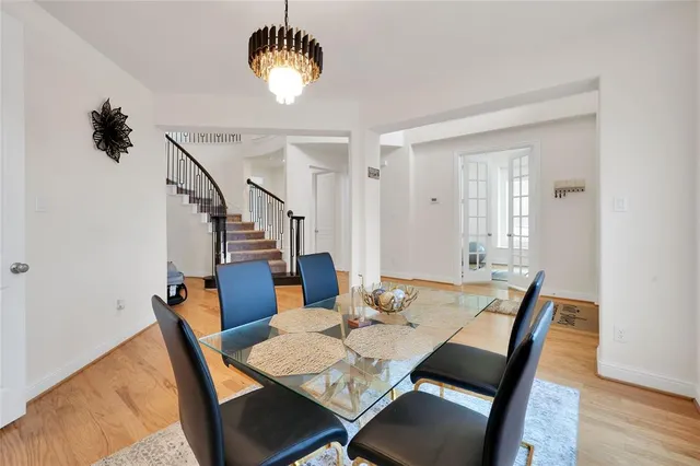 a view of a dining room with furniture wooden floor and chandelier