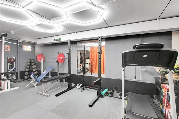 a room with gym equipment and mirror
