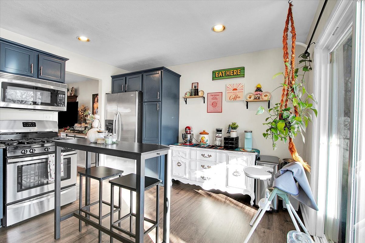 1203 Riverside Avenue Streator, IL 61364 - Photo 5 of 15 a kitchen with stainless steel appliances a stove a refrigerator and a dining table