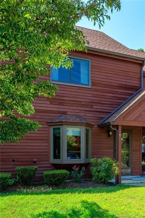 33 Wyndham Landing, Unit 33 Killingly, CT 06239 - Photo 1 of 1 a front view of a house with garden