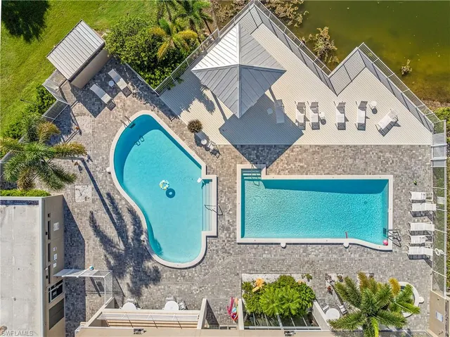 an aerial view of a house with a swimming pool and outdoor space