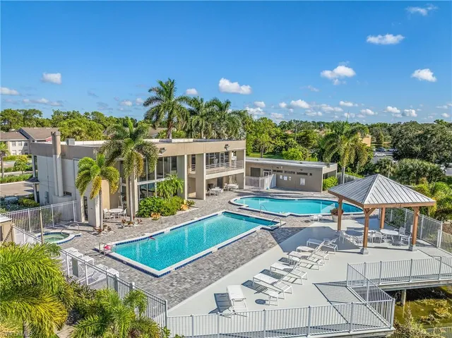 a view of a patio with swimming pool table and chairs