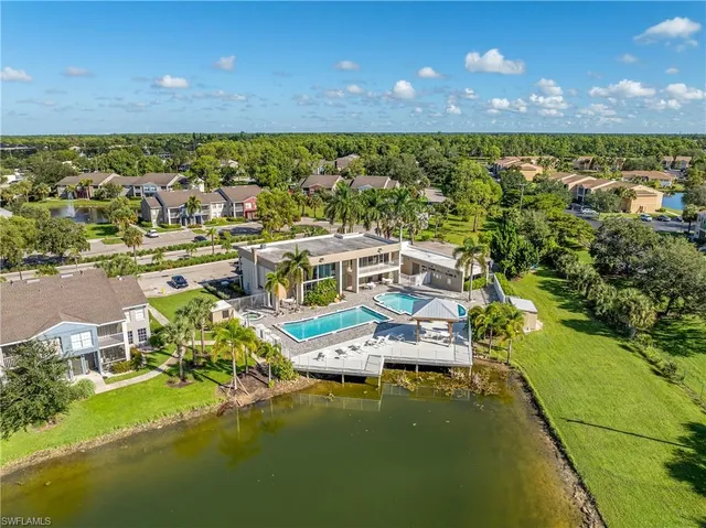 a view of residential houses with outdoor space and swimming pool
