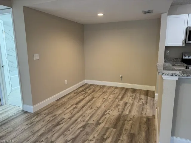 a view of a room with wooden floor and sink