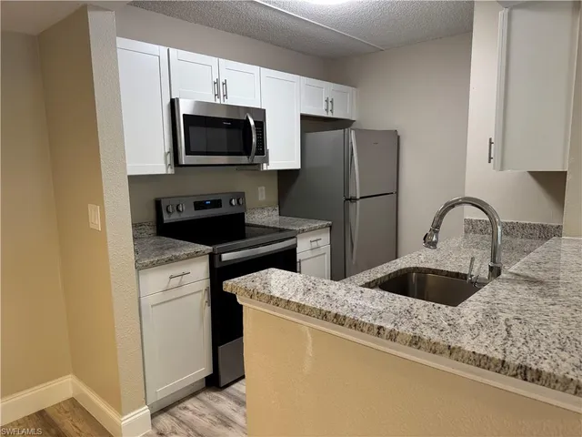 a kitchen with a sink and a microwave