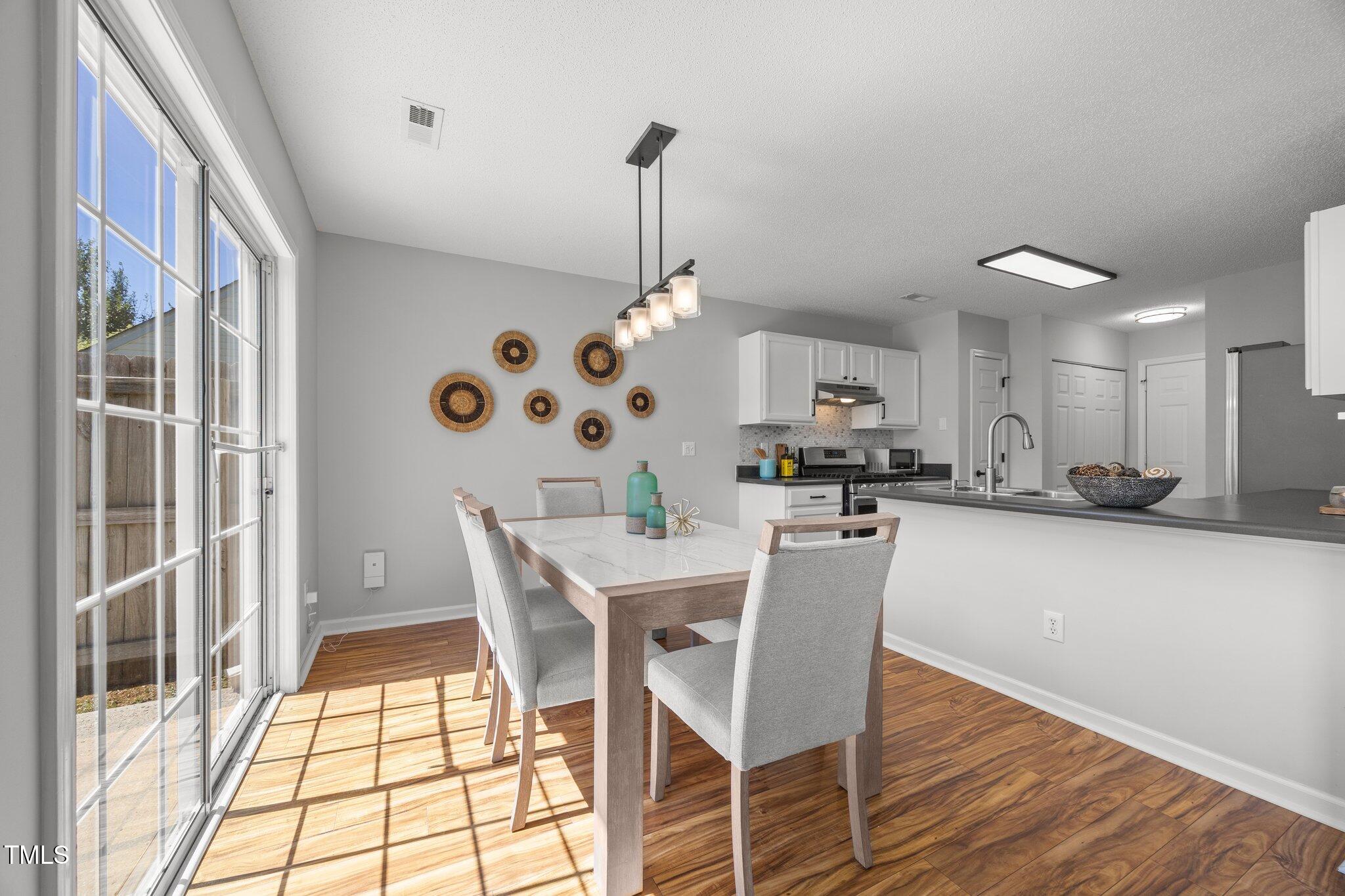 5300 Roan Mountain Place Raleigh, NC 27613 - Photo 8 of 27 a dining room with furniture and wooden floor