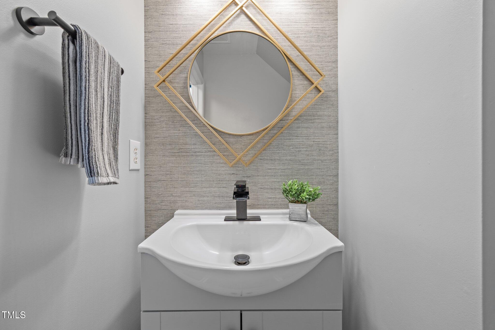 5300 Roan Mountain Place Raleigh, NC 27613 - Photo 15 of 27 a bathroom with a sink and a mirror