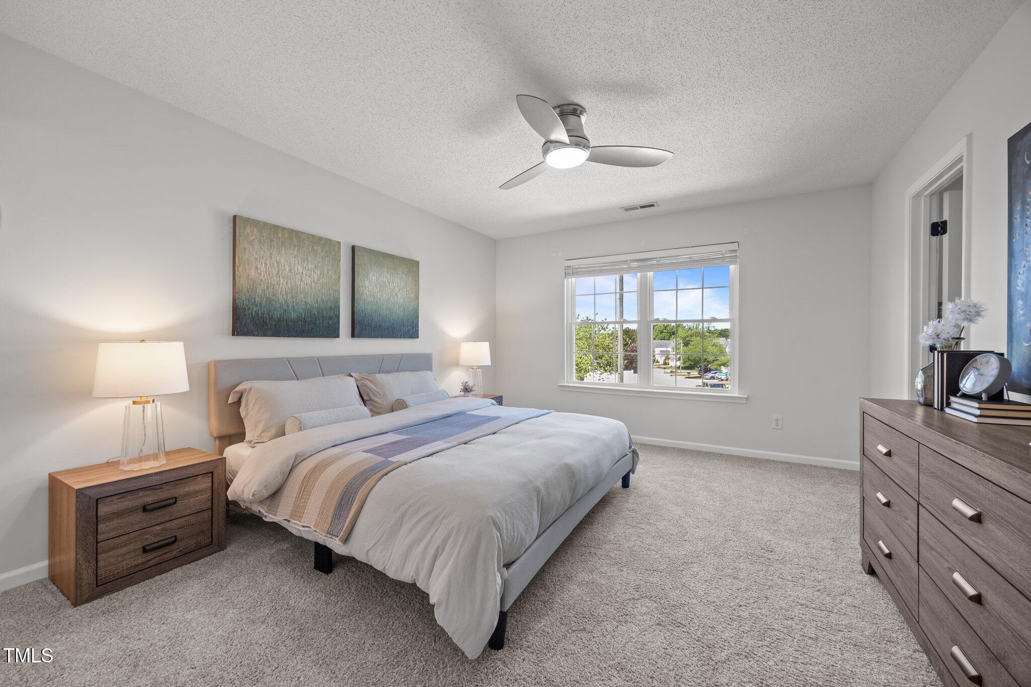 5300 Roan Mountain Place Raleigh, NC 27613 - Photo 17 of 27 a bedroom with a bed and a dresser with the outer view