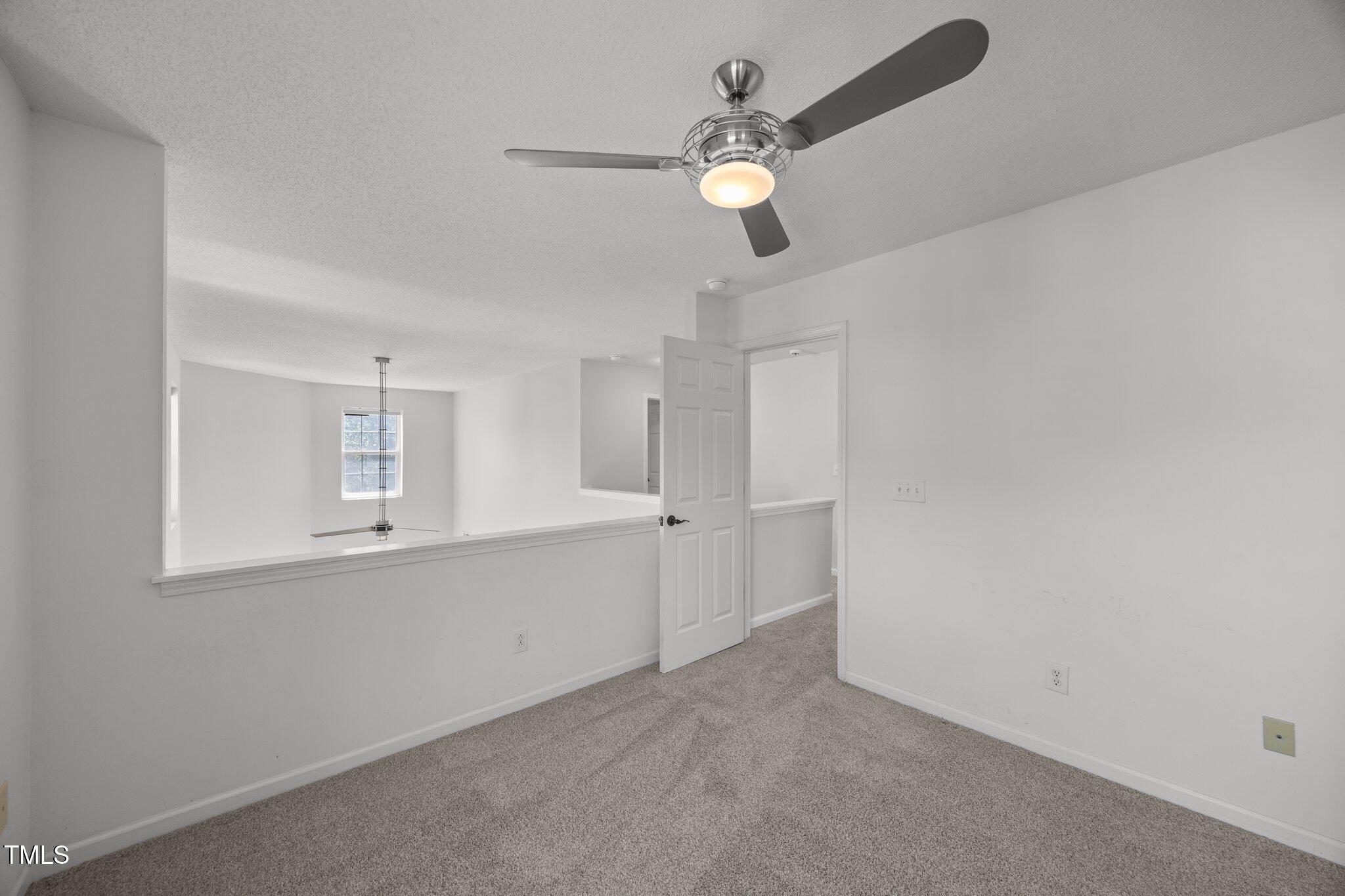 5300 Roan Mountain Place Raleigh, NC 27613 - Photo 21 of 27 a view of an empty room with window and wooden floor