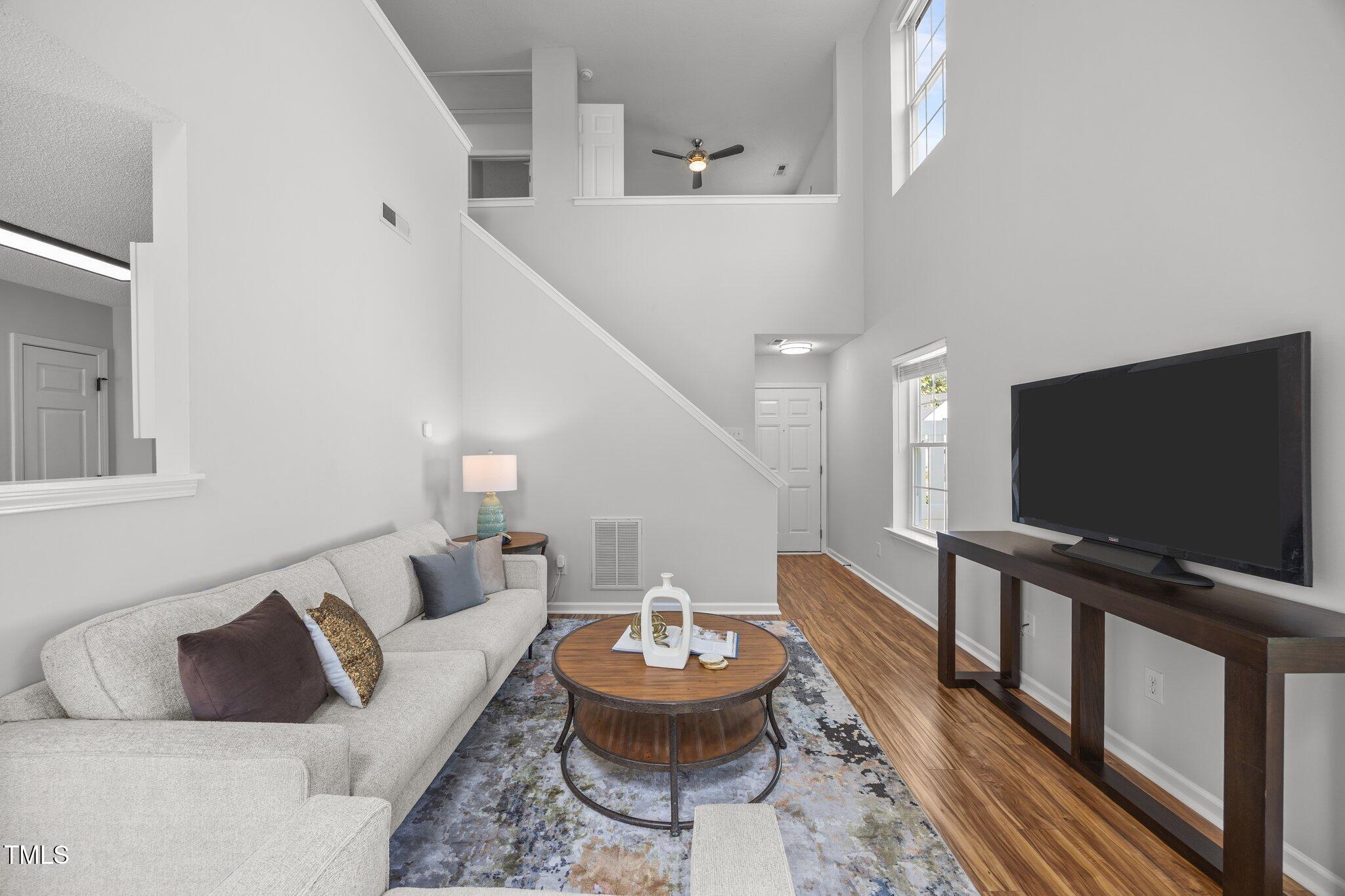 5300 Roan Mountain Place Raleigh, NC 27613 - Photo 4 of 27 a living room with furniture and a flat screen tv