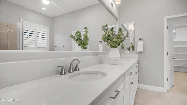 a bathroom with a double vanity sink and a mirror