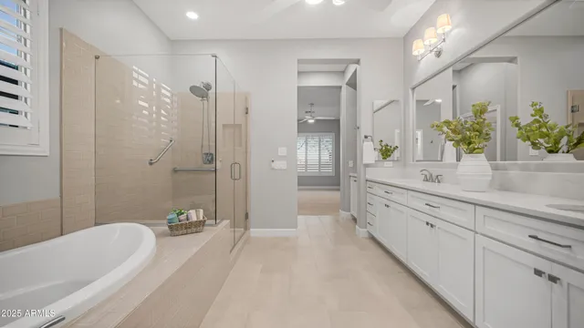 a spacious bathroom with a granite countertop tub sink a shower and a mirror
