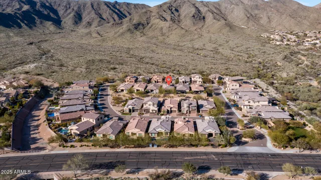 an aerial view of residential house and sandy dunes