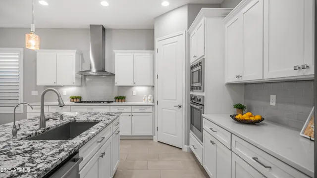 a kitchen with stainless steel appliances white cabinets and a stove