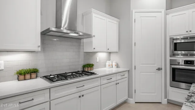 a kitchen with stainless steel appliances granite countertop a stove microwave and refrigerator